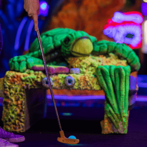 Putt Mania golf ball lined up to be putted on an under the sea themed mini golf hole with a sea tutle tunnel prop