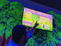 Man pointing up at Putt Mania leadboard screen