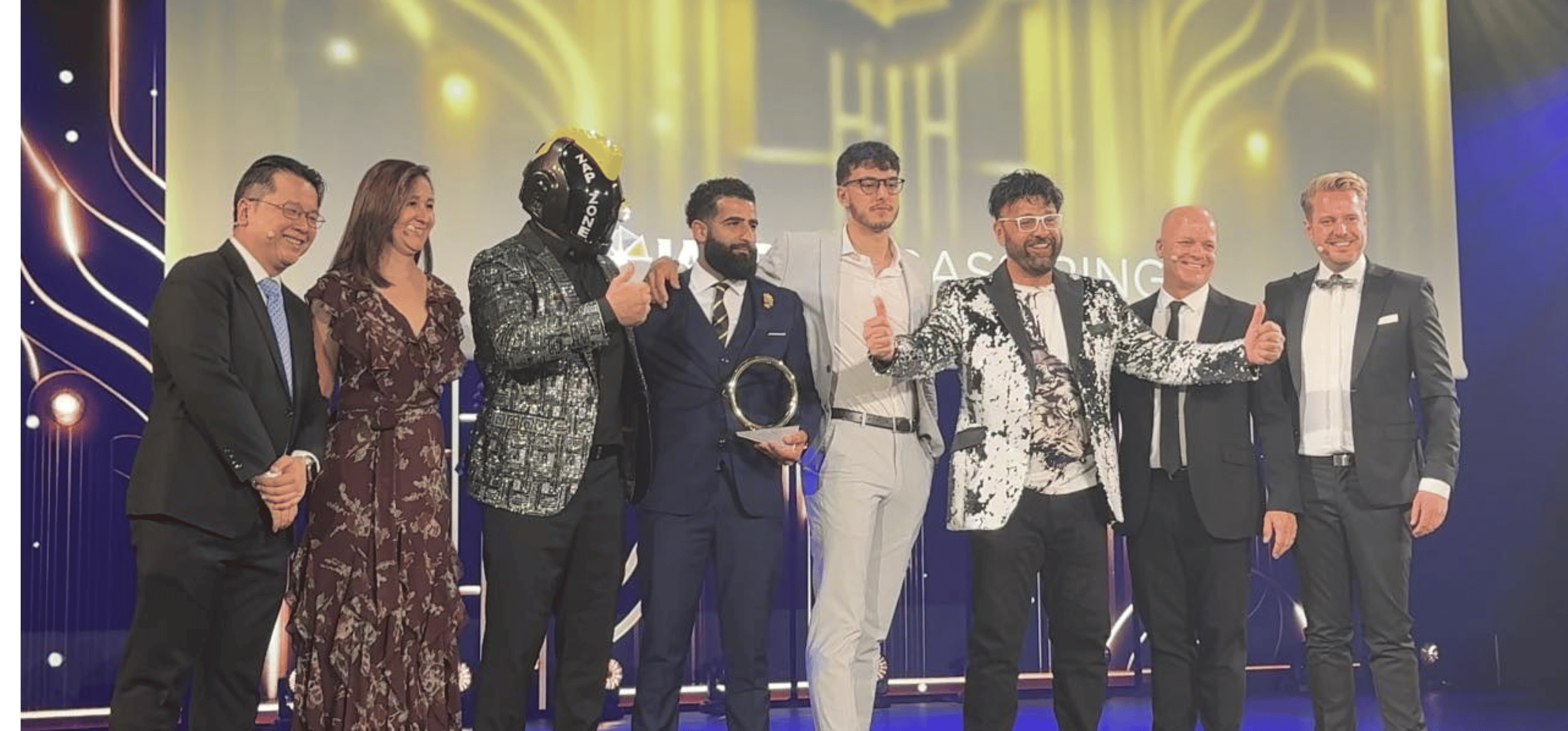 A line of men and woman on a stage in dress attire at the IAAPA Honors award ceremony.