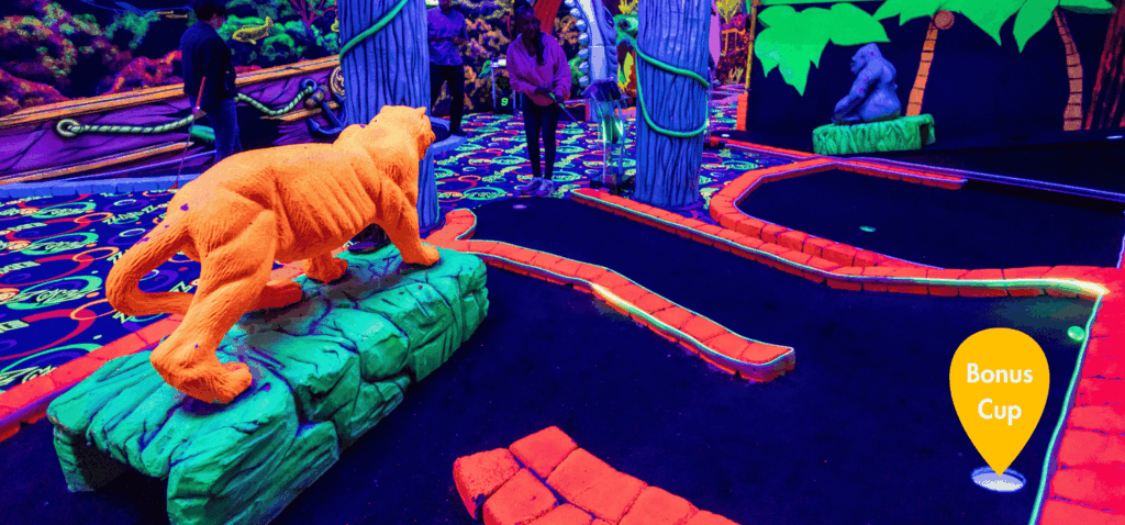 Jungle theme mini golf hole with Putt Mania bonus cup highlighted