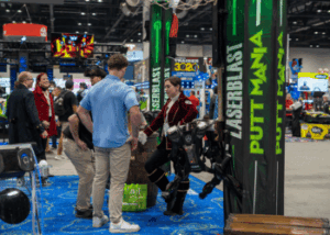 People at the LaserBlast booth at the 2024 IAAPA Expo.