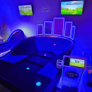 Tiered indoor mini glow golf hole with several scoring cups and Putt Mania technology.