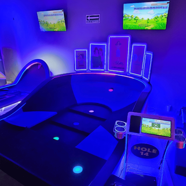 Tiered indoor mini glow golf hole with several scoring cups and Putt Mania technology.